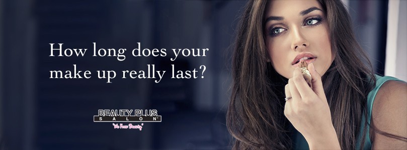 Woman putting red lipstick looking in mirror